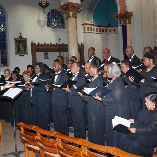 A conductor conducting singers in a choir